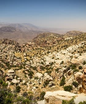 A rocky mountain landscape featuring rugged terrain and sparse vegetation under a clear sky. - Olive Oil Times