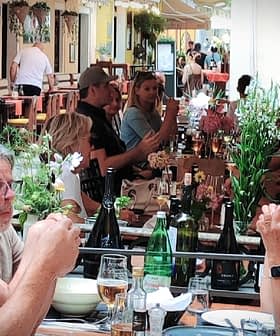 A couple sitting at a table in a restaurant, engaged in conversation while dining. - Olive Oil Times