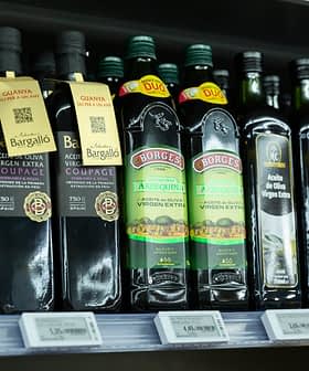 Various bottles of extra virgin olive oil displayed on a supermarket shelf. - Olive Oil Times
