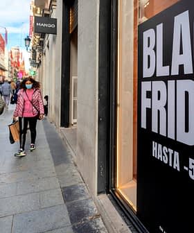 Large sign displaying 'Black Friday' with discount information on a city street. - Olive Oil Times