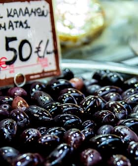 A bowl of black Kalamata olives displayed for sale with a price tag of 7.50 euros. - Olive Oil Times