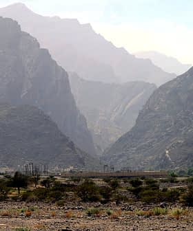 A view of a mountainous landscape featuring steep hills and valleys under a hazy sky. - Olive Oil Times