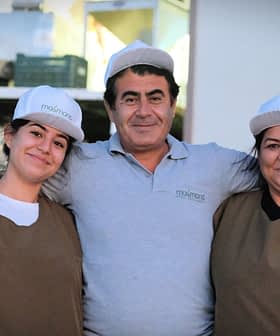 Three individuals wearing caps and work attire posing together outdoors. - Olive Oil Times