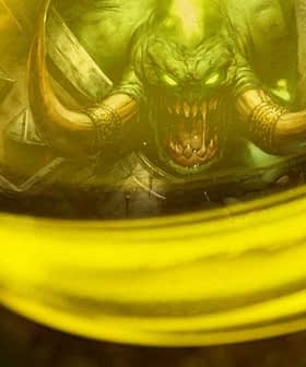 Close-up of a jar containing green liquid with a demon illustration visible inside. - Olive Oil Times