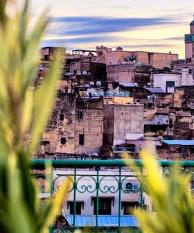 Panoramic view of the Fes Medina with a prominent minaret in the background. - Olive Oil Times