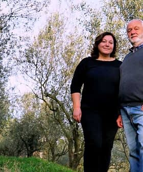 Orjana Hrvatin and Timotej Zupan standing together in an olive grove. - Olive Oil Times