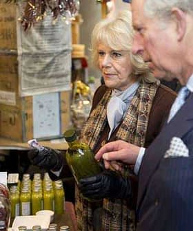 Charles et Camilla inspectent une bouteille d'huile d'olive sur un étal de marché. Olive Oil Times