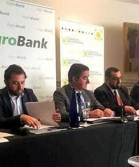 Panel of six individuals seated at a table during an AgroBank press conference. - Olive Oil Times