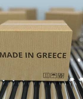 Cardboard box labeled 'Made in Greece' on a conveyor belt among other boxes. - Olive Oil Times