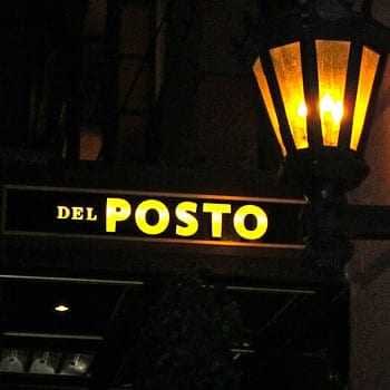Illuminated sign reading 'Del Posto' with a lantern above it. - Olive Oil Times