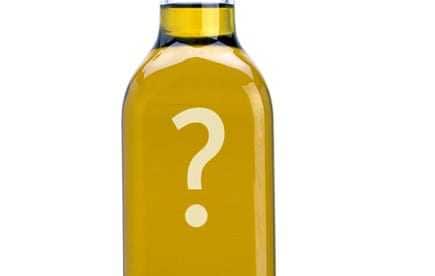 Transparent bottle of olive oil featuring a large question mark on the label. - Olive Oil Times