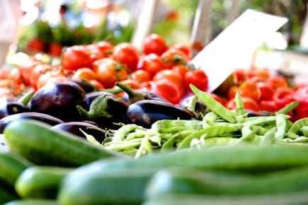 A selection of fresh vegetables including cucumbers, eggplants, and green beans displayed at a market. - Olive Oil Times