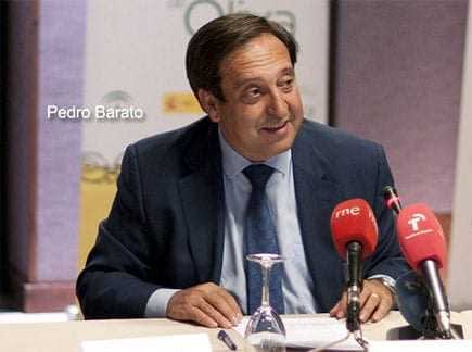A man named Pedro Barato speaking at a conference with microphones in front of him. - Olive Oil Times