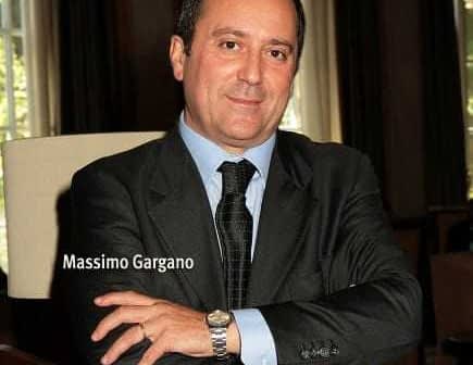 Portrait of Massimo Gargano with arms crossed, wearing a suit and tie. - Olive Oil Times