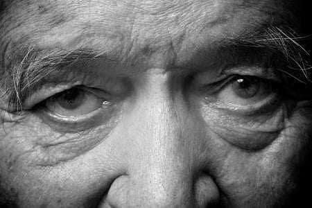 Close-up image of an elderly man's eyes with visible wrinkles and detailed features. - Olive Oil Times
