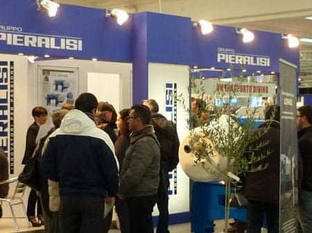 Piaralisi exhibition booth with attendees interacting at a trade show event. - Olive Oil Times