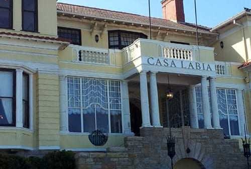 Exterior view of Casa Labia, a yellow building with decorative features and columns. - Olive Oil Times