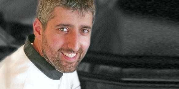 Portrait of Yiannis Tsivourakis smiling while wearing a chef's uniform. - Olive Oil Times