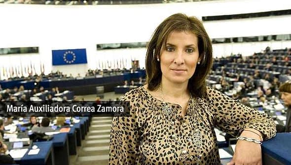Maria Auxiliadora Correa Zamora posing in the European Parliament chamber with a leopard print top. - Olive Oil Times
