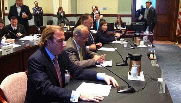 A group of individuals seated at a conference table during a meeting in a formal setting. - Olive Oil Times