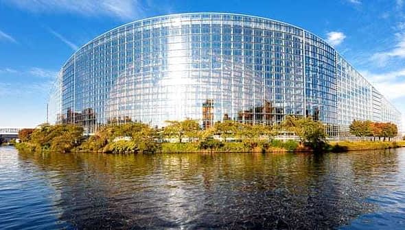 Modern glass structure of the European Parliament building located in Strasbourg, France, reflecting sunlight. - Olive Oil Times