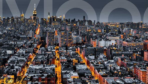 Aerial view of New York City skyline at night with illuminated buildings and streets. - Olive Oil Times