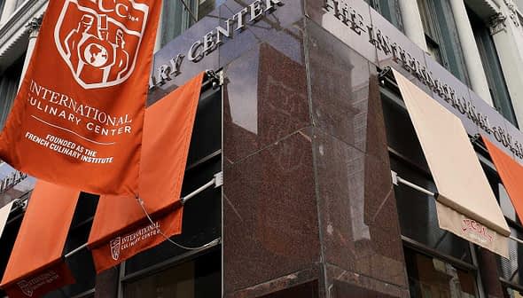 Exterior view of the International Culinary Center with banners on the facade. - Olive Oil Times