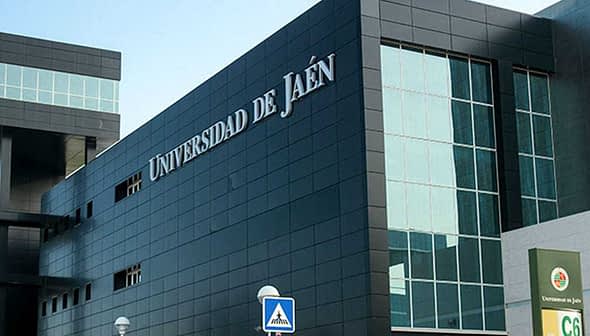 Modern architecture of the Universidad de Jaén with large glass windows and a black exterior. - Olive Oil Times