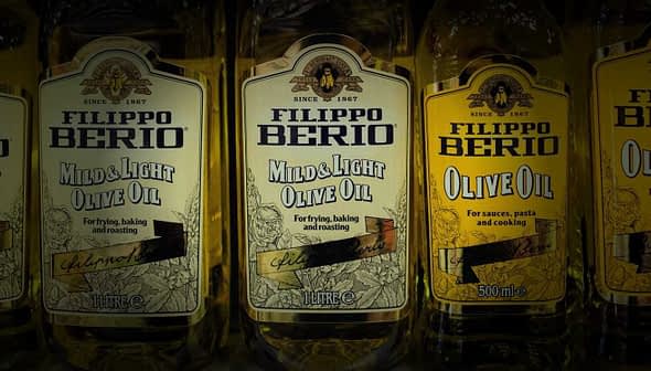Row of Filippo Berio olive oil bottles, including Mild & Light and Olive Oil varieties. - Olive Oil Times
