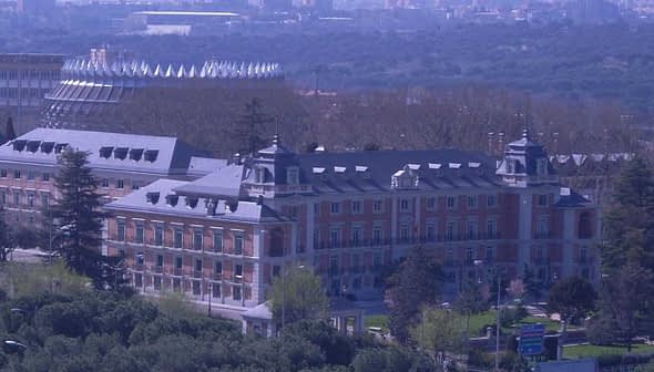 Moncloa Palace, a historical building in Madrid, Spain, surrounded by trees and greenery. - Olive Oil Times