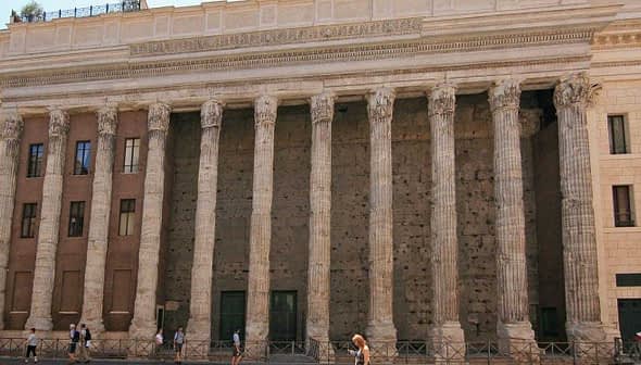 The Temple of Hadrian in Rome features tall columns and a stone facade with a historical architectural design. - Olive Oil Times
