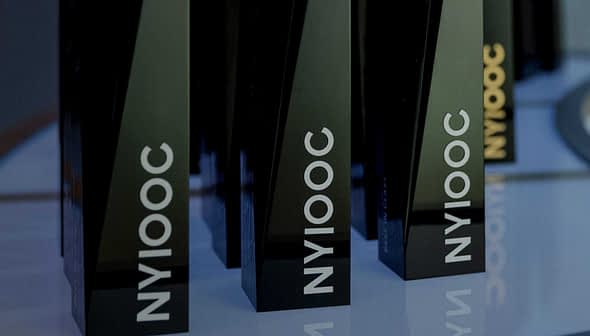 Black trophies with the inscription 'NYIOOC' displayed on a shelf. - Olive Oil Times