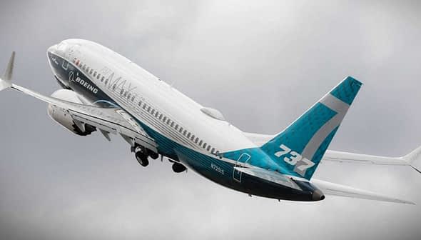 Boeing 737 aircraft taking off with a blue and white livery against a cloudy sky. - Olive Oil Times