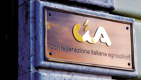 Bronze plaque displaying the logo and name of Confederazione Italiana Agricoltori. - Olive Oil Times