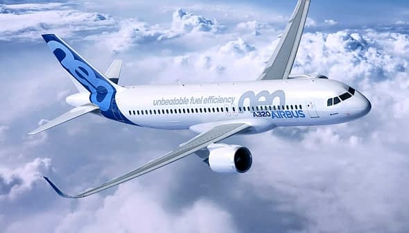 Airbus A320neo aircraft flying above the clouds with a blue and white livery. - Olive Oil Times