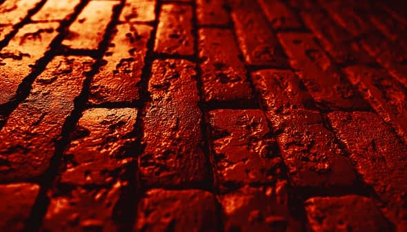 Close-up view of a textured red brick surface with visible imperfections and patterns. - Olive Oil Times