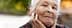 Elderly woman with gray hair and a thoughtful expression, resting her chin on her hand. - Olive Oil Times