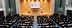 Vue intérieure d'une grande salle de conférence lors d'une réunion de l'Organisation mondiale du commerce avec des participants assis. - Olive Oil Times