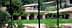 A residential complex featuring buildings with red doors and landscaped greenery. - Olive Oil Times