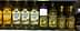 Différentes bouteilles d'huile d'olive exposées sur une étagère de supermarché, notamment les marques Filippo Berio et Colavita. - Olive Oil Times