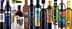 Various bottles of olive oil with distinct labels and designs arranged in a row. - Olive Oil Times