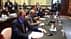 Un grupo de personas sentadas en una mesa de conferencias durante una reunión en un entorno formal. Olive Oil Times