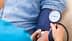A healthcare professional measuring blood pressure using a sphygmomanometer on a patient's arm. - Olive Oil Times