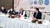 Group of officials seated at a table during a press conference with microphones and a Turkish flag. - Olive Oil Times