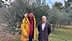Two men posing for a photo in an olive grove with olive trees in the background. - Olive Oil Times
