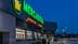 Exterior view of a Mercadona supermarket with illuminated signage during dusk. - Olive Oil Times