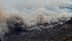 Fumaça espessa saindo de um incêndio florestal com chamas visíveis em uma região montanhosa. - Olive Oil Times