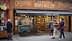 Shopfront of Le Comptoir de Mathilde featuring a chocolatier display and a bicycle cart. - Olive Oil Times