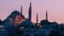 A view of a mosque in Istanbul with multiple minarets during dusk, illuminated by soft lighting. - Olive Oil Times