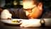 Chef closely inspecting a plate of food with a fork in hand, focused on the dish. - Olive Oil Times